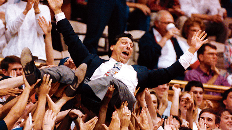 Photo of basketball coach Jim Valvano carried by audience members Photo of basketball coach Jim Valvano carried by audience members